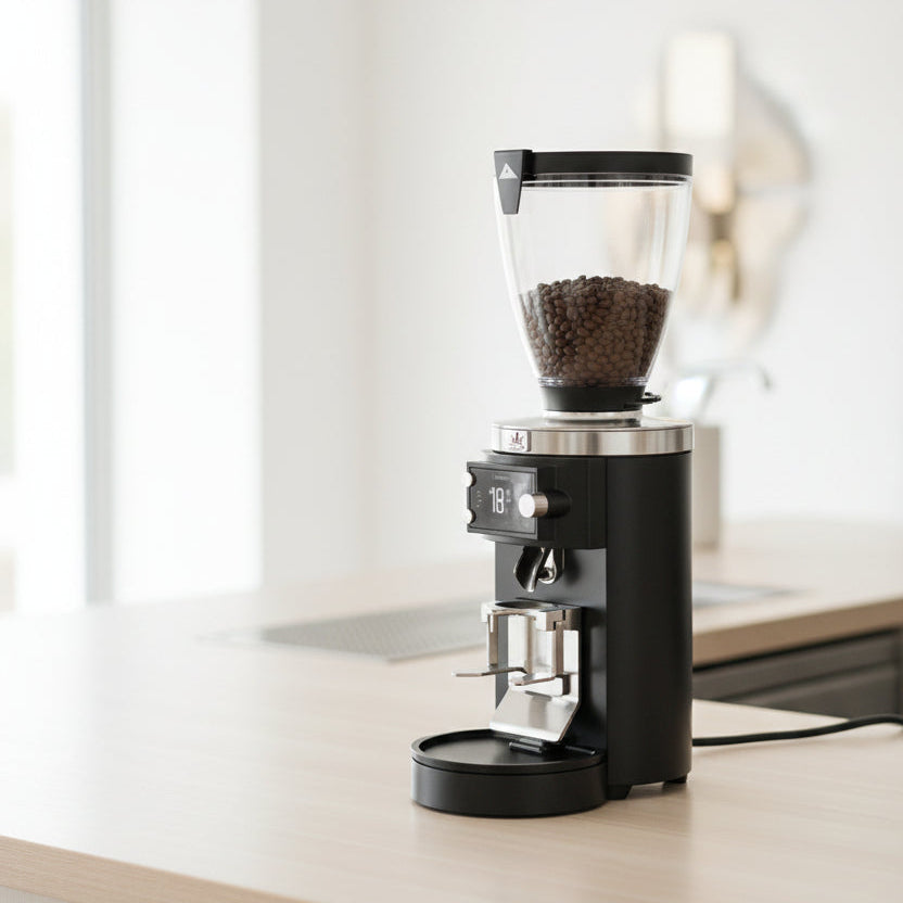 Coffee grinder with a clear container showing coffee beans on a white background