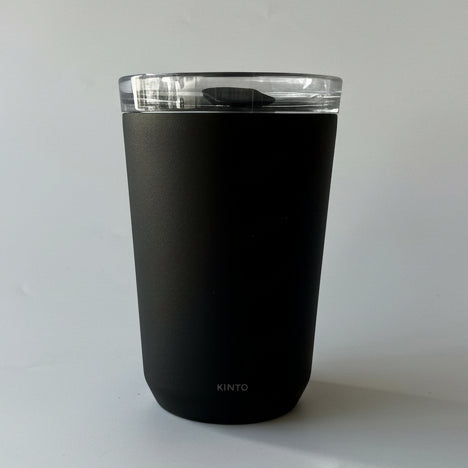 Black tumbler with a clear lid on a white background