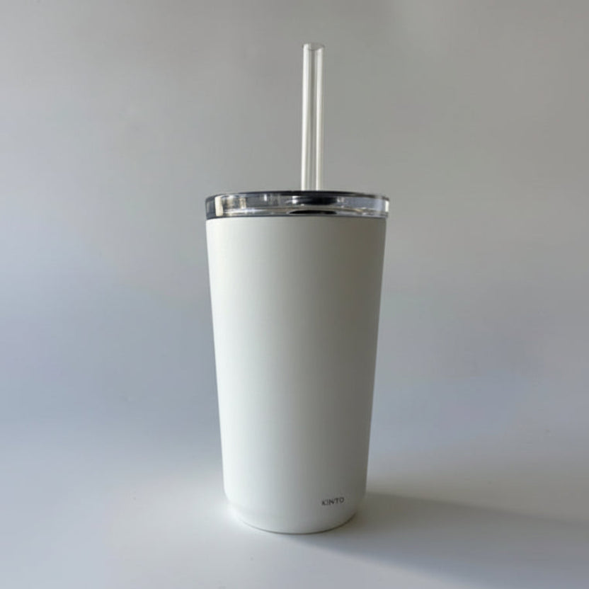 Beige tumbler with a straw on a white background