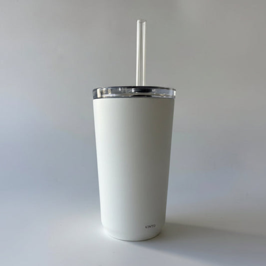 Beige tumbler with a straw on a white background