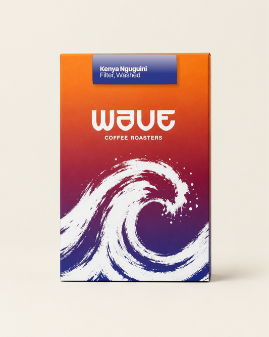 A rectangular coffee roaster box standing upright on a light beige background. The box has a bright orange-to-purple-to-blue gradient design with a large white wave illustration and the visible brand name 'wave coffee roasters' with specialty coffee label: 'Kenya Nguguini Filter, Washed'