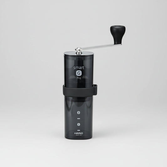 Black manual coffee grinder with 'smart G' branding on a white background